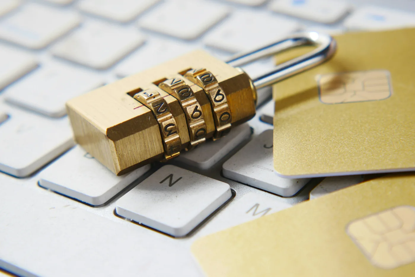 Padlock on a keyboard with credit cards — Identity Theft Protection California | Blackstone Insurance