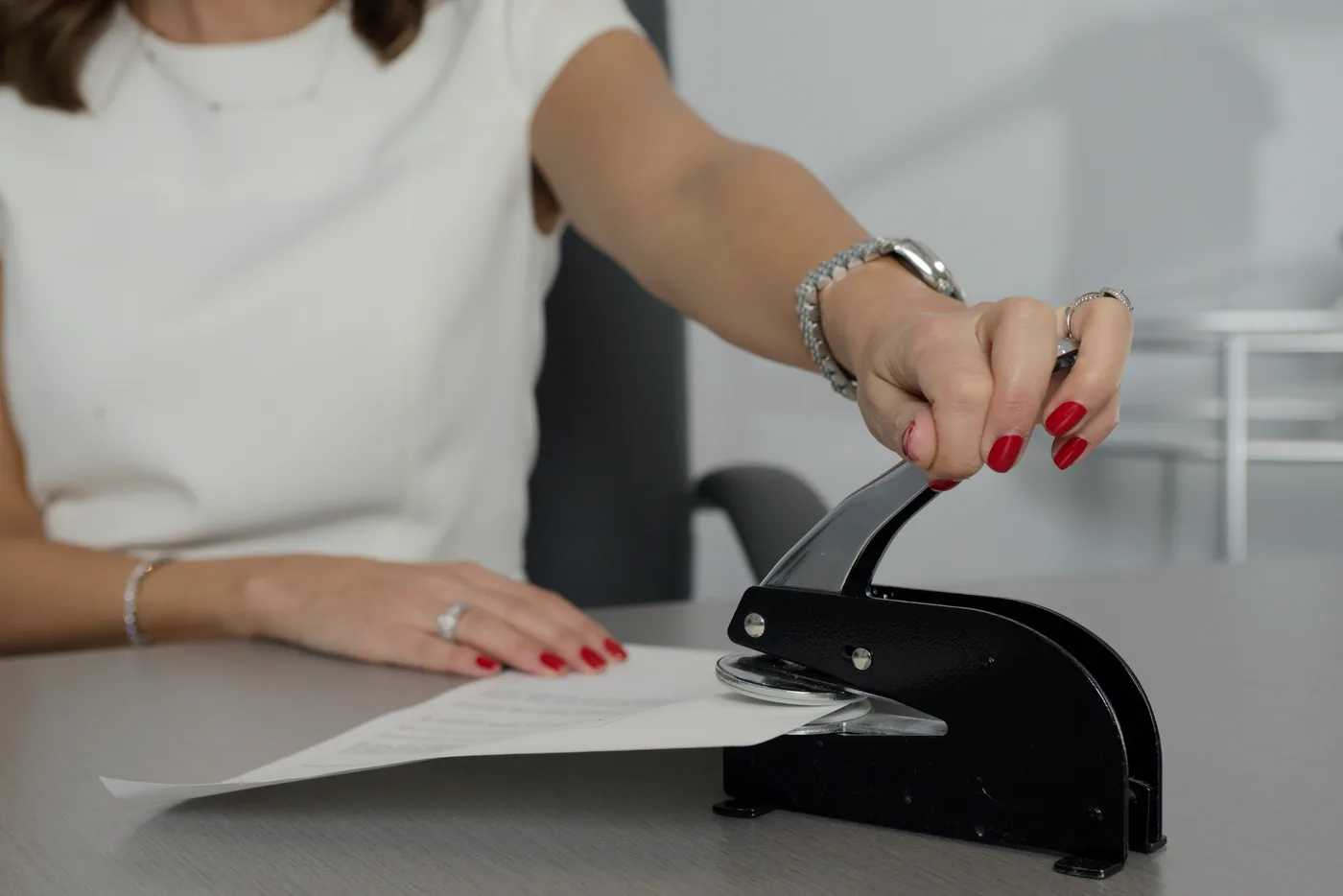 Notary embosser stamping a document — California Notary Bond (Bond-84) | Blackstone Insurance